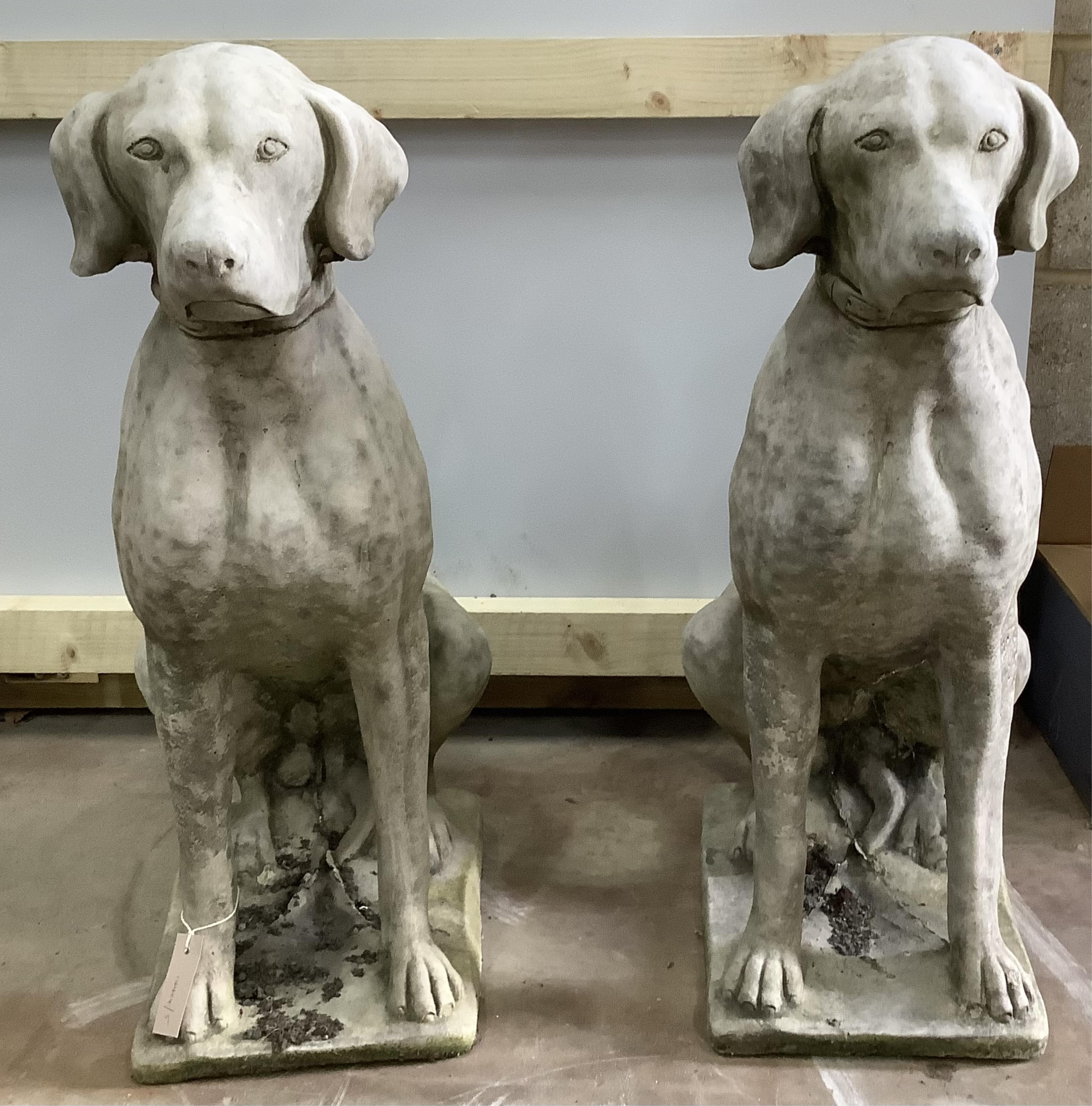 A pair of reconstituted stone seated hound garden ornaments, height 71cm